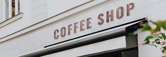 coffee shop exterior sign inviting coffee lovers to enjoy two delicious brews