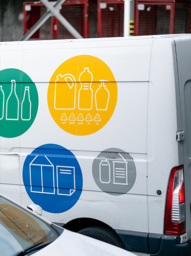 delivery van with recycling symbols and containers in green yellow and blue representing different materials for waste management and recycling 2 types of containers 2 recycling logos