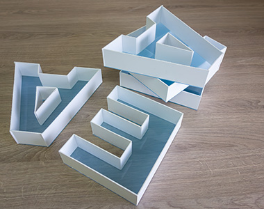 stacked geometric paper shapes on wooden surface ideal for creative projects and organization