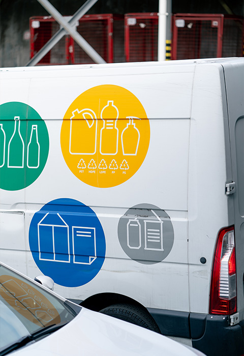 van with recycling symbols representing different container types green bottle yellow bottle and recycling icon emphasizing sustainable practices for two types of materials