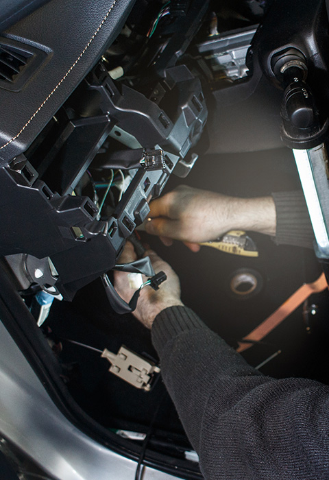 hands working on car dashboard components for repair and installation of car audio system parts optimization for two different types