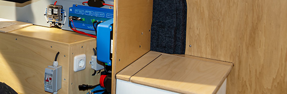 interior view of a wooden panel setup featuring electrical components and a storage area showcasing efficient four panel design